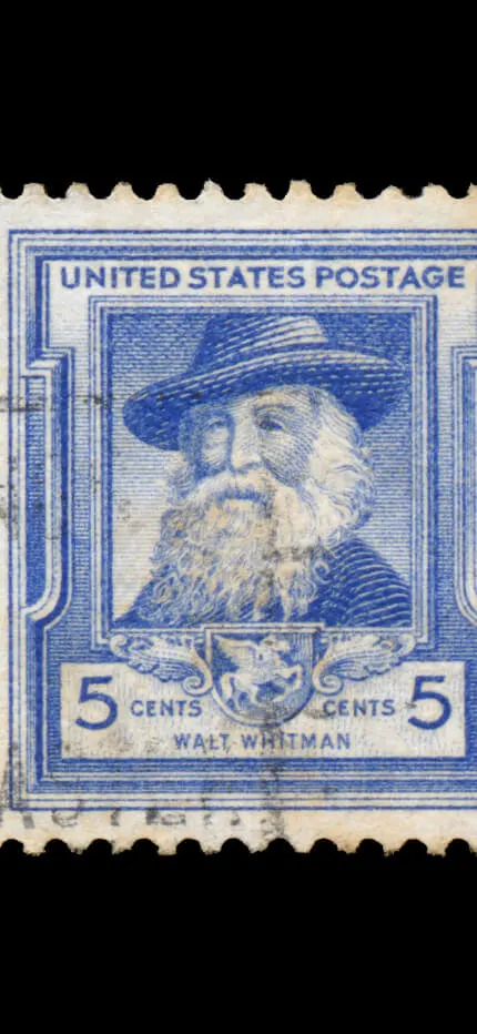 Close-up of the blue Walt Whitman five-cent United States Postage stamp portrait.